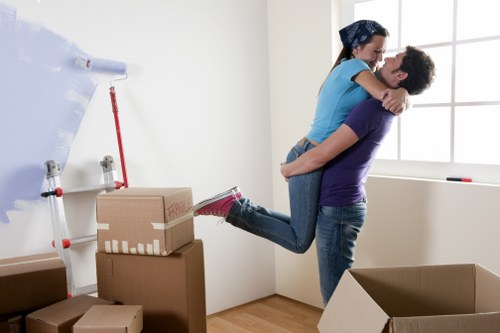 Movers handling furniture during a flat move in Enfield
