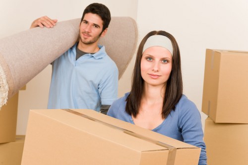 Careful packing of household items by movers in Enfield