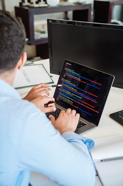 A computer screen displaying HTML code with lines of text, tags such as <html>, <head>, <title>, and <body>, along with code-related elements like styles and links. The screen is in a dimly lit enviro
